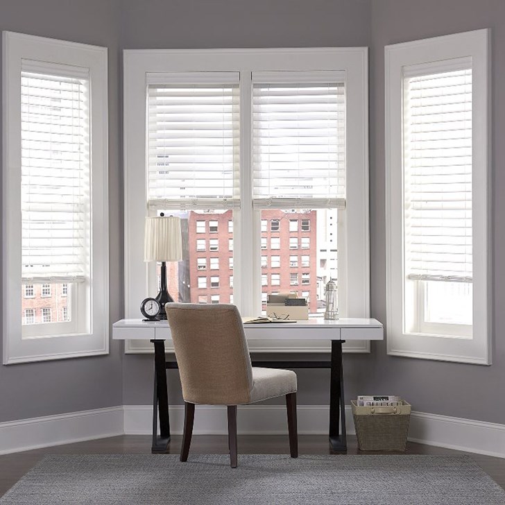 The large slat 2 1/2 Inch Faux Wood Blinds shown in the pattern Embossed White