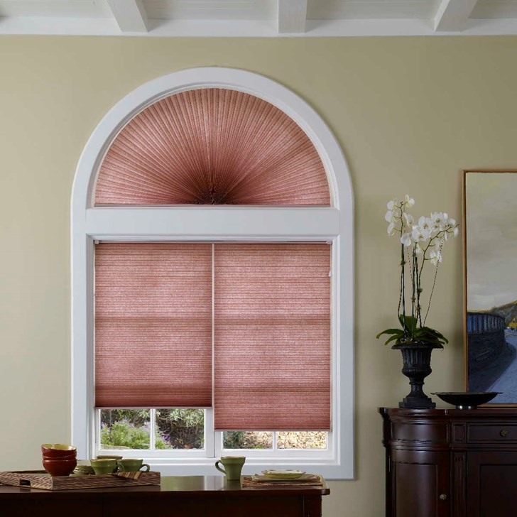 The 2-on-1 headrail helps make operating your shades easier by reducing stress on hardware mechanisms and providing the flexibility to raise one shade while keeping the other lowered.  Paired with the Cellular Arch. Color: Spice DLF-848