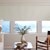 Vignette of a Mid-Century Modern Living room scene of the Motorized Blackout Roller Shades in the Catania Off-White color with an Inside Mount.