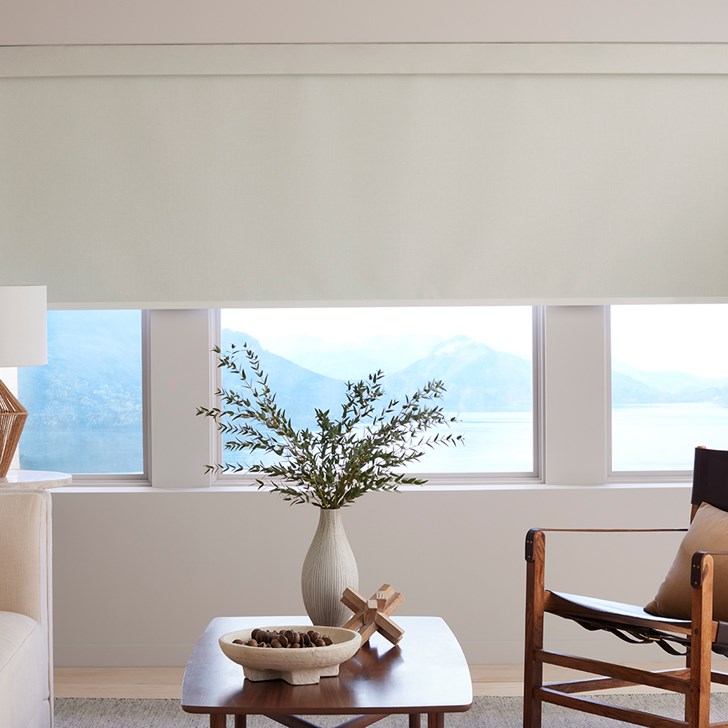 The Motorized Blackout Roller Shades in the Catania Off-White color with the Fabric Wrapped 4in. Cornice.
