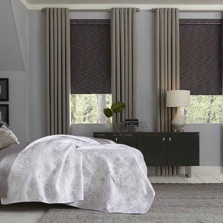 Blackout roller shade paired with the easy grommet drapery. Shade Color: Cascade Blackout Graphite 36005; Drapery Color: Rio Stone