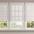 Vignette of the Light Filtering Roller Shades in the Brook White Sand color with the Large Cassette and Outside Mount.